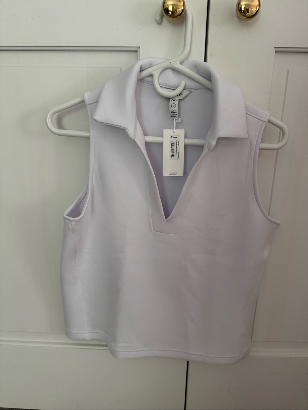 Spanx sleeveless white polo, size Medium
